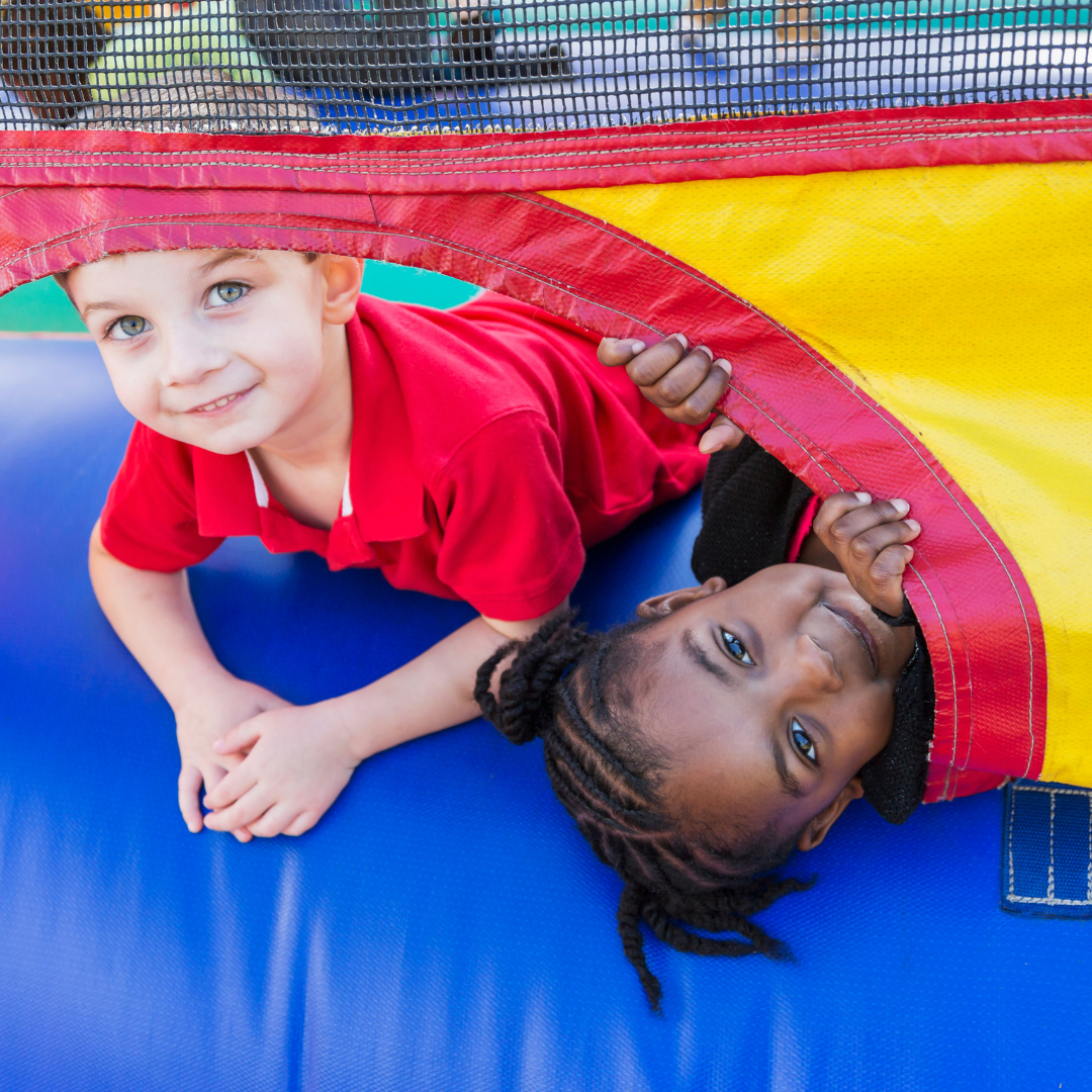 Children having fun in a colorful bounce house rental at a backyard birthday party in Valdosta, Georgia